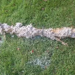 debris removed from dirty duct in grass